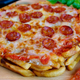 Illustration for article titled Pepperoni pizza made with french fries crust is a delicious way to die